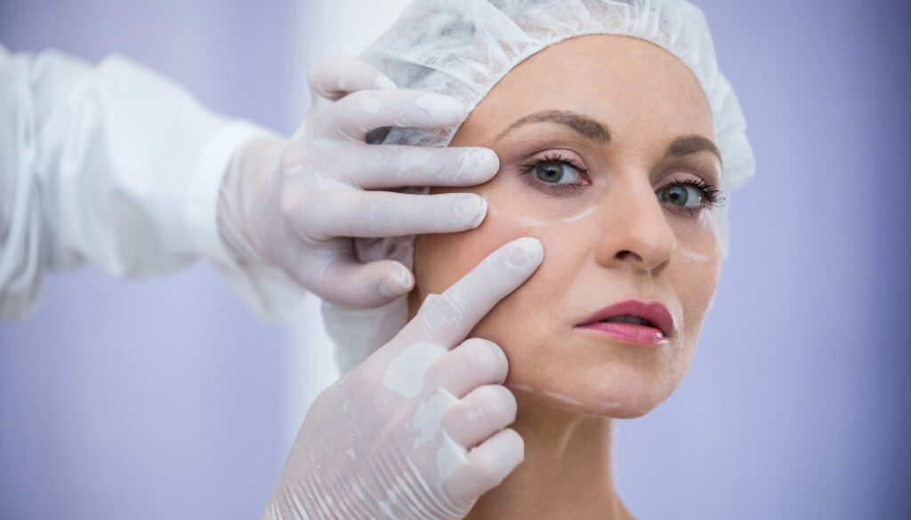 doctor-examining-female-patients-face-cosmetic-treatment