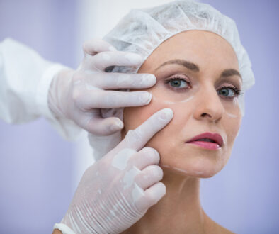 doctor-examining-female-patients-face-cosmetic-treatment